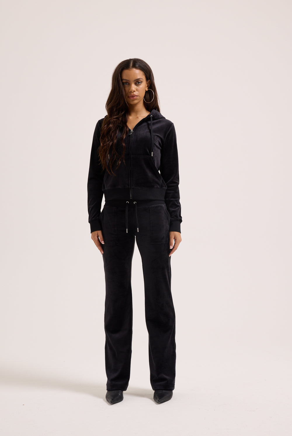 Woman wearing a black outfit on a white background