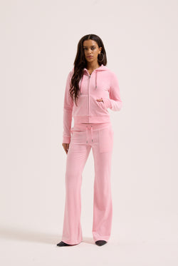 Displays a model wearing the Pink Classic 'Juicy' branded Velour Robertson Hoodie 