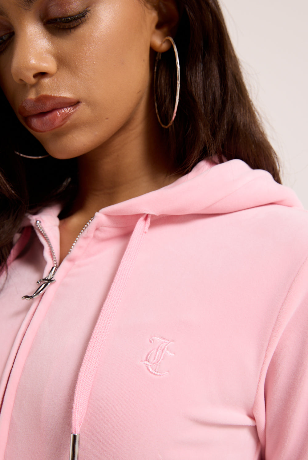 Displays a model wearing the Pink Classic 'Juicy' branded Velour Robertson Hoodie 