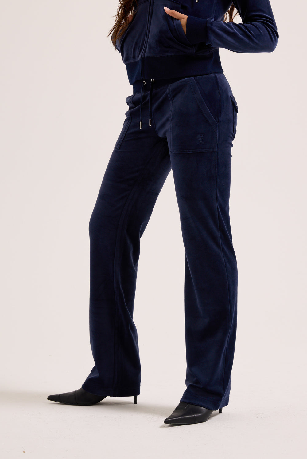 Navy blue outfit with pants and a top on a white background