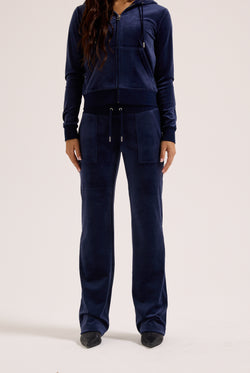 Navy blue tracksuit worn by a person on a white background