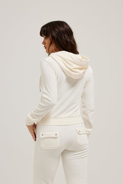 Displays a model wearing the cream classic 'Juicy' branded velour Robertson hoodie 