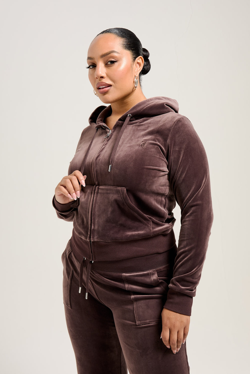 Displays a model wearing the Java 'Juicy' branded classic velour Robertson hoodie 