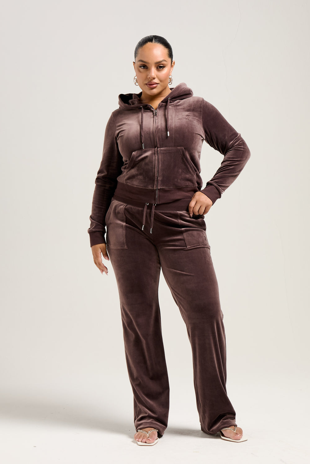 Displays a model wearing the Java 'Juicy' branded classic velour Robertson hoodie 