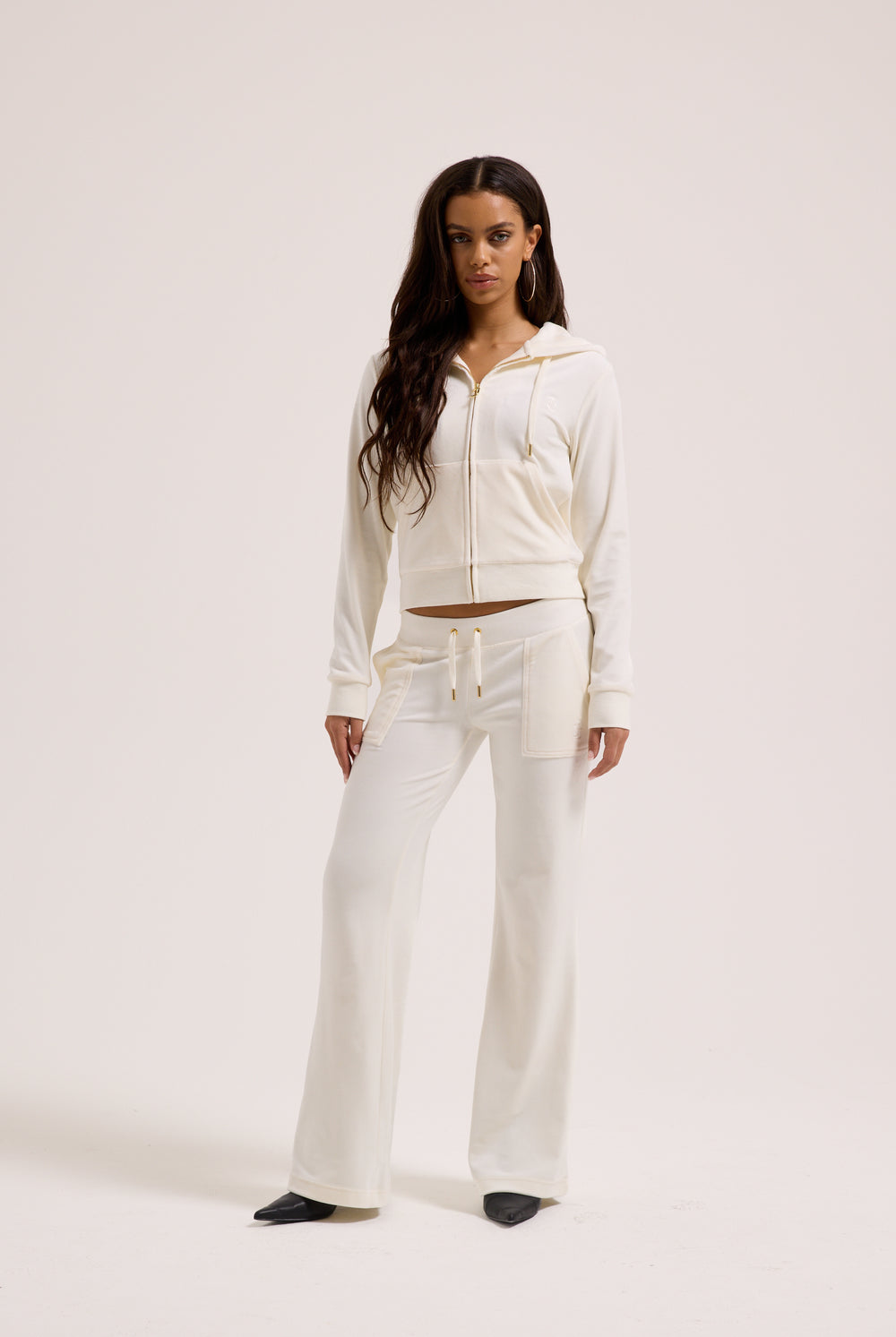 Displays a model wearing the Cream & Gold 'Juicy' branded velour Robertson hoodie 