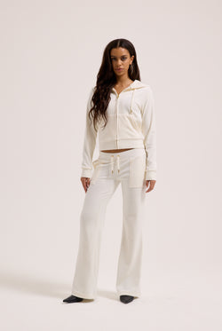Displays a model wearing the Cream & Gold 'Juicy' branded velour Robertson hoodie 