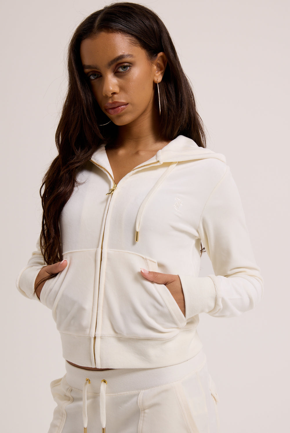 Displays a model wearing the Cream & Gold 'Juicy' branded velour Robertson hoodie 