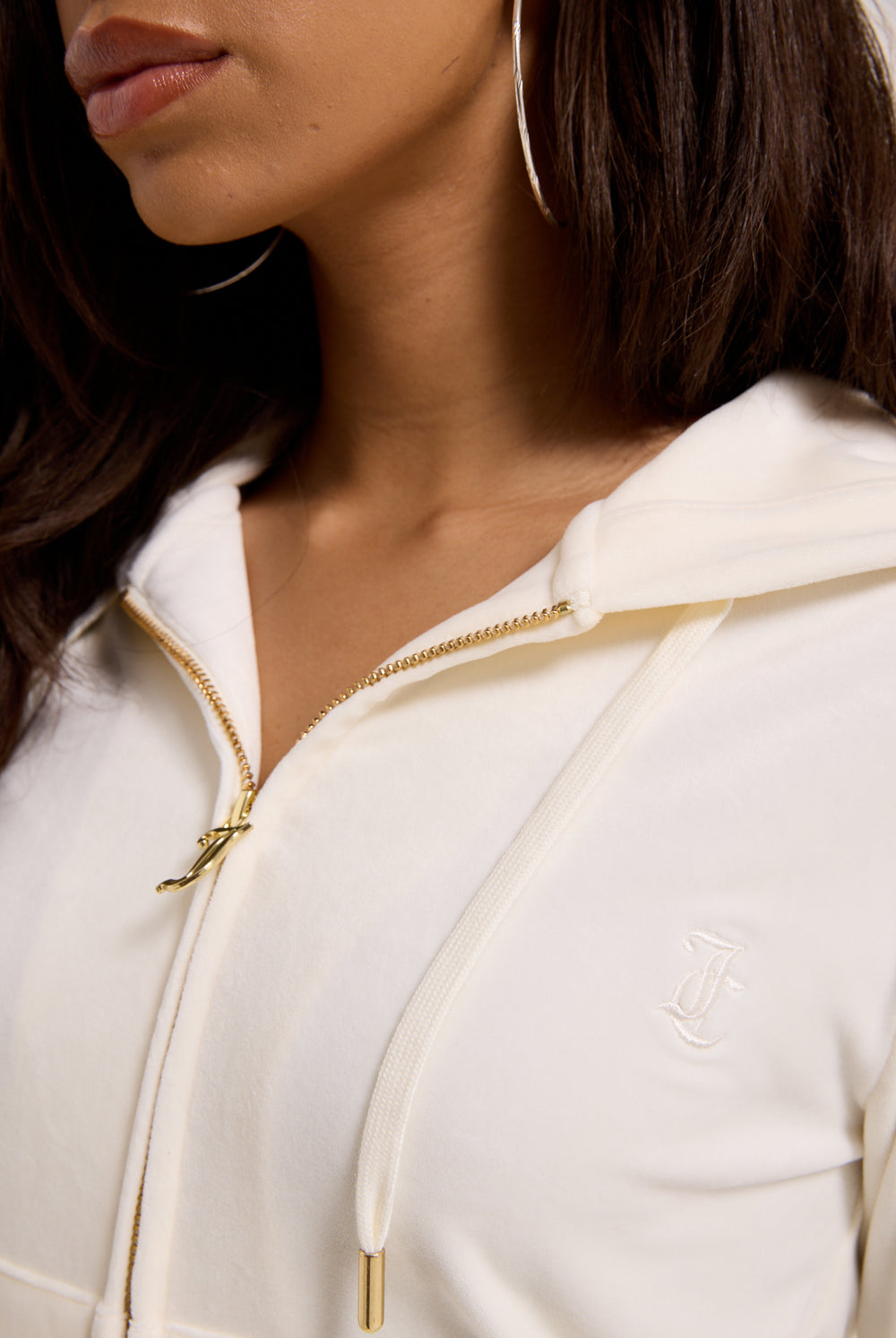 Displays a model wearing the Cream & Gold 'Juicy' branded velour Robertson hoodie 