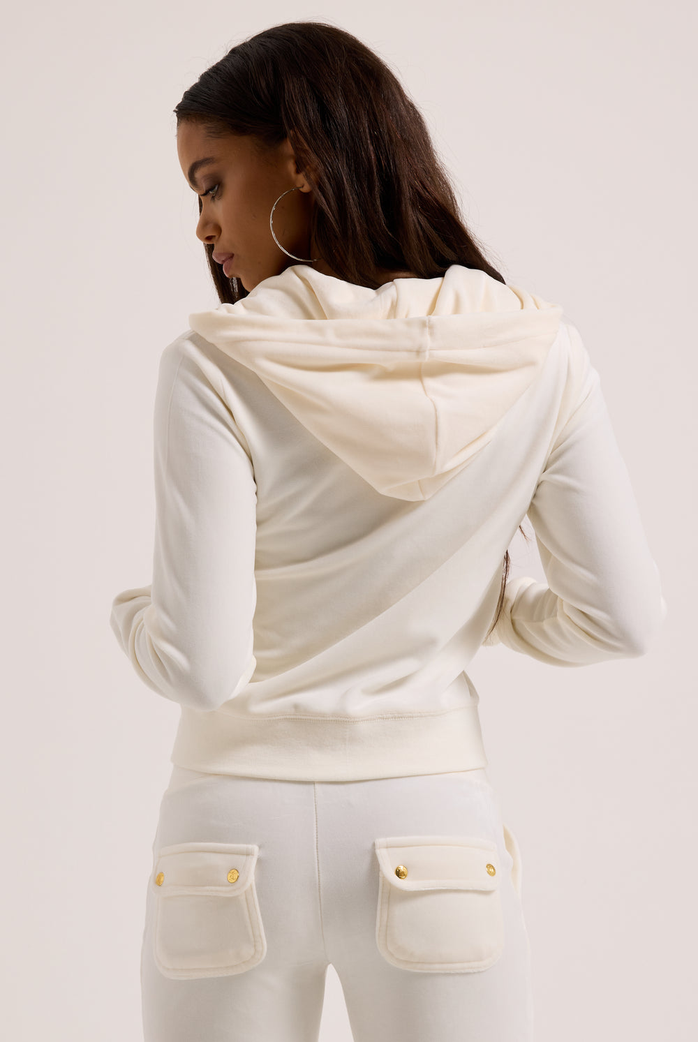 Displays a model wearing the Cream & Gold 'Juicy' branded velour Robertson hoodie 