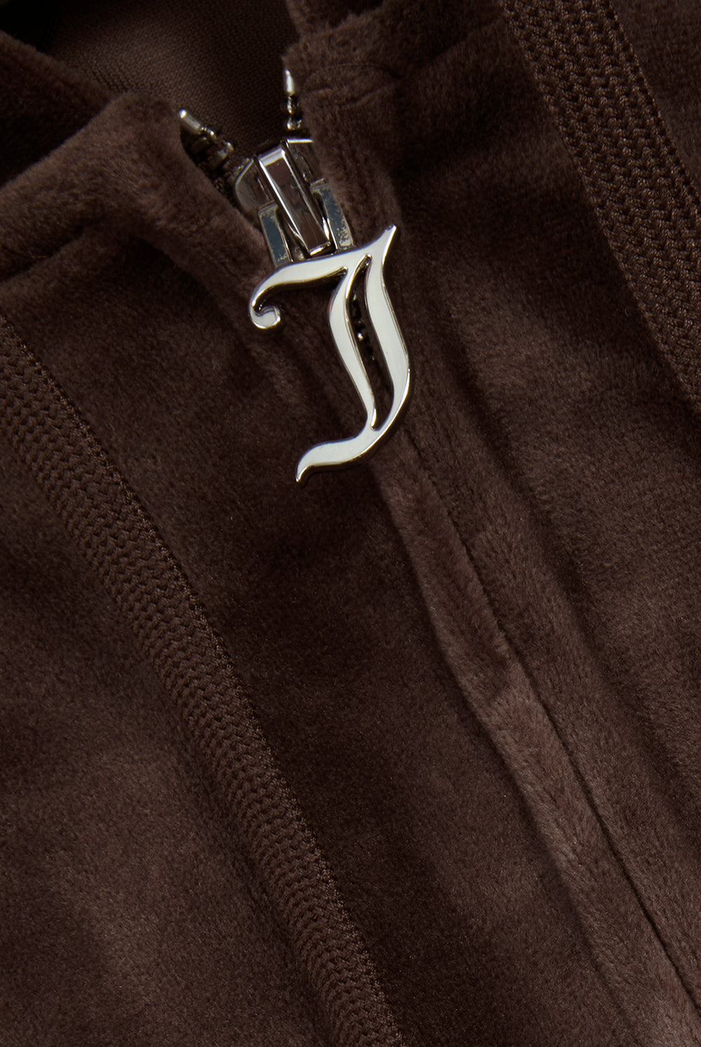 Displays a model wearing the Java 'Juicy' branded classic velour Robertson hoodie featuring the juicy couture branding on the zip