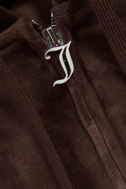 Displays a model wearing the Java 'Juicy' branded classic velour Robertson hoodie featuring the juicy couture branding on the zip