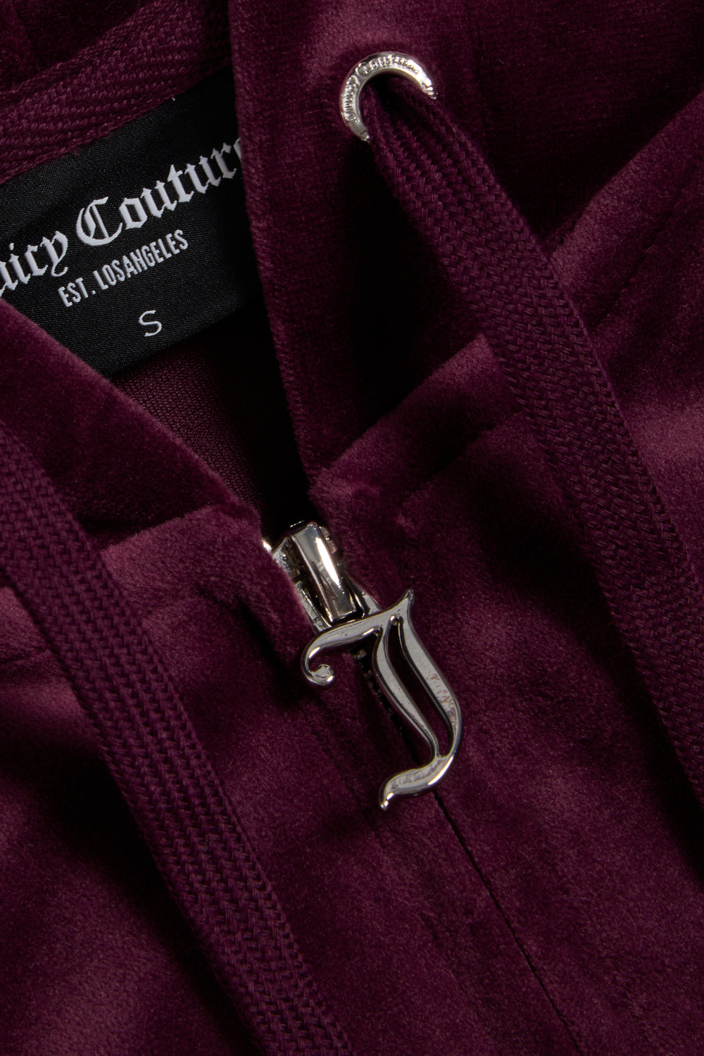 Displays the wine tasting classic 'juicy' branded velour Robertson hoodie featuring the juicy zip 