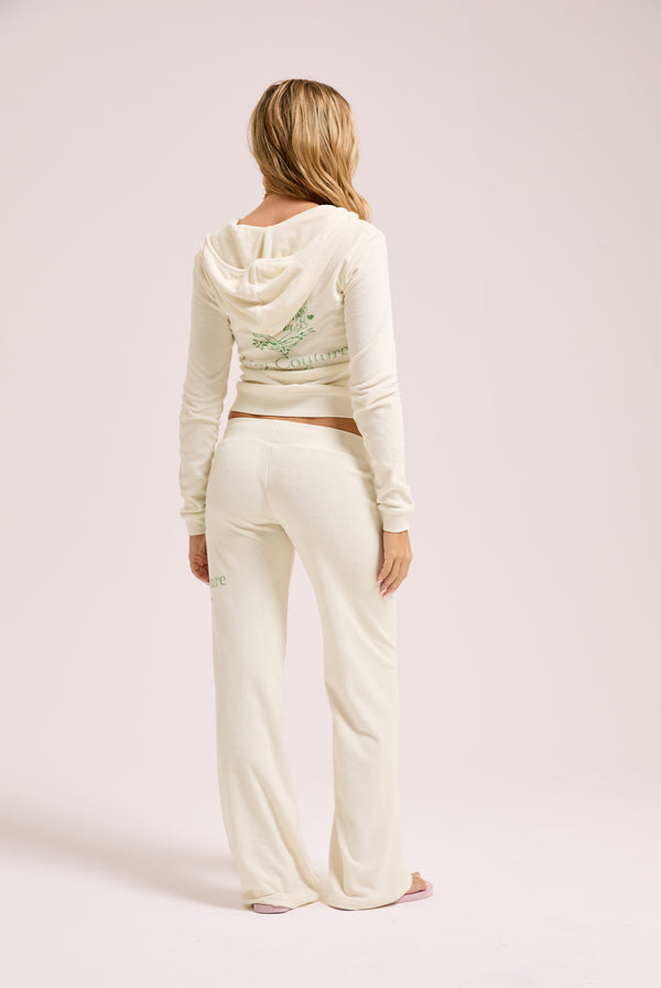 Displays a model wearing the Marshmallow Towelling 'Juicy' branded chateau hoodie and bottoms 
