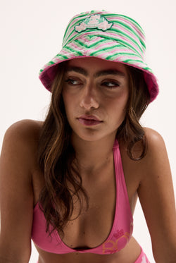 Displays a model wearing the Azalea pink Roxy & Juicy couture reversible bucket hat  