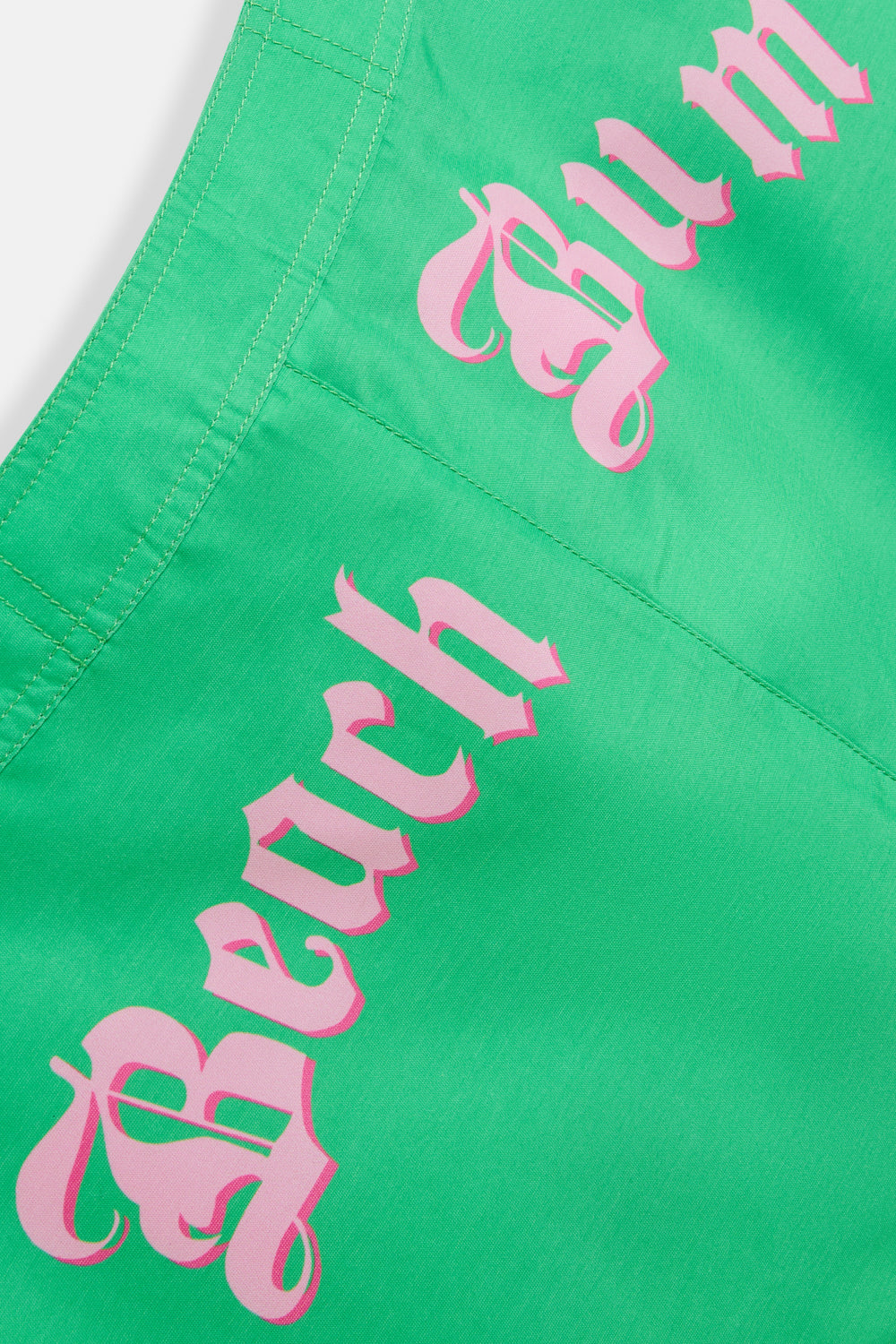 Displays the island green Roxy and Juicy couture beach bum skirt featuring the beach bum branding 