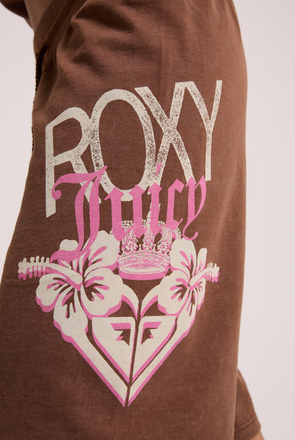Displays a model wearing the Tiramisu Roxy & Juicy couture relaxed jorts featuring the Roxy x juicy Couture logo