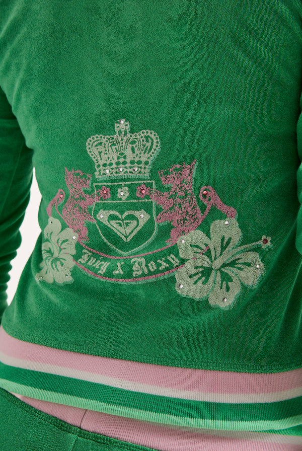 Displays a model wearing the island green Roxy & Juicy Couture Terry towelling hoodie featuring the juicy Couture  x Roxy logo
