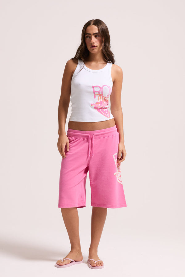 Displays a model wearing the White Roxy & Juicy couture tank top 