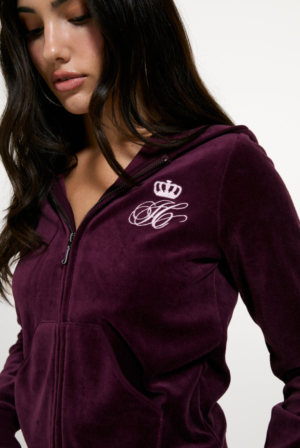 Displays a model wearing the Winetasting 'Juicy' branded Script Rebelle Robyn Hoodie