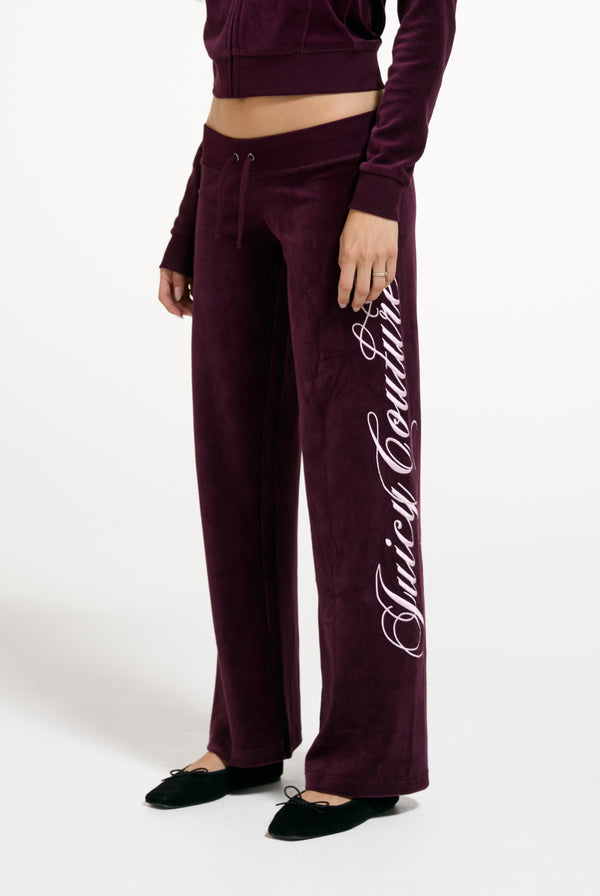 Displays a model wearing the Winetasting 'Juicy' branded Cotton Velour Ultra Lowrise Straight Leg Trackpant