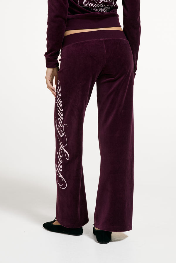 Displays a model wearing the Winetasting 'Juicy' branded Cotton Velour Ultra Lowrise Straight Leg Trackpant