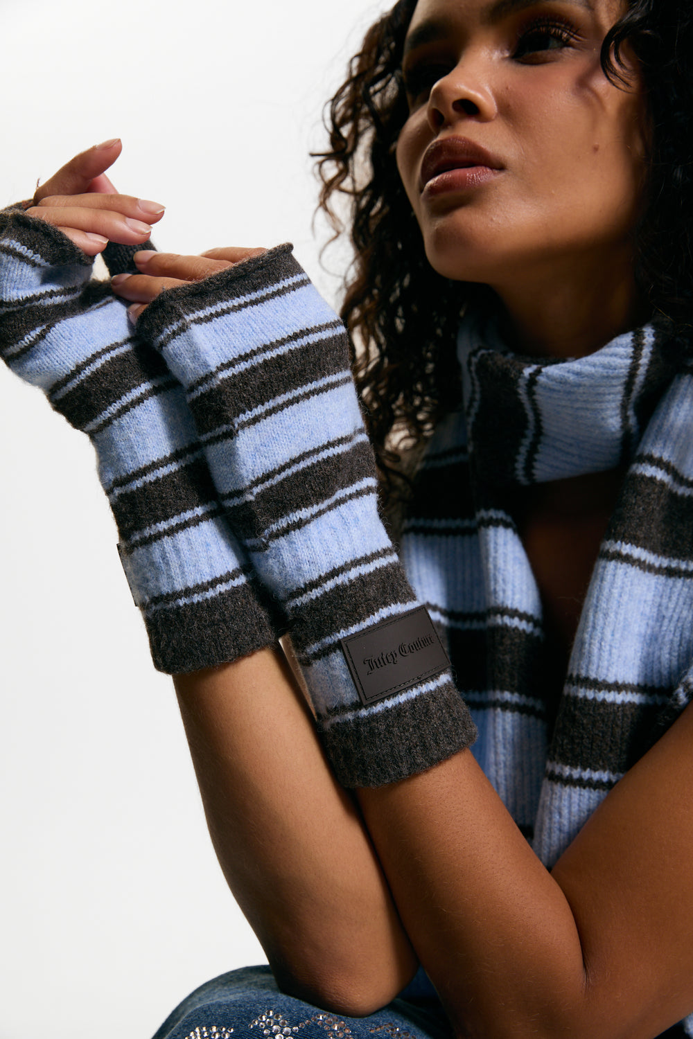 Displays a model wearing the Java Stripe 'Juicy' branded Fingerless Mittens