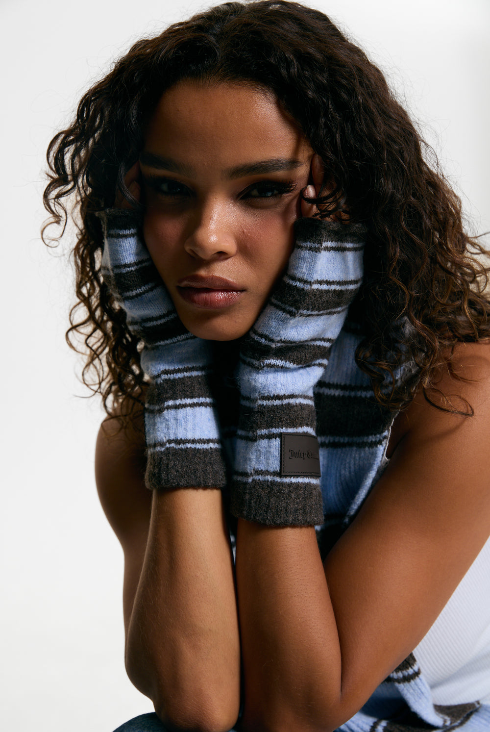 Displays a model wearing the Java Stripe 'Juicy' branded Fingerless Mittens