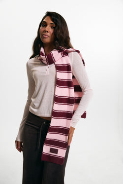 Displays a model wearing the Burgundy 'juicy' branded Stripe Knit Scarf