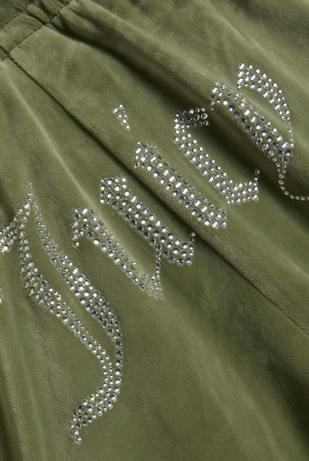 Displays the Oil Green 'Juicy' branded Velour Diamanté Tracksuit Bottom featuring the juicy branding 