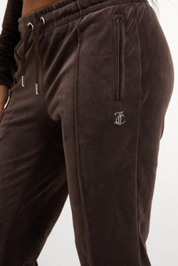 Displays a model wearing the Java 'Juicy' branded Velour Diamanté Tracksuit Bottom