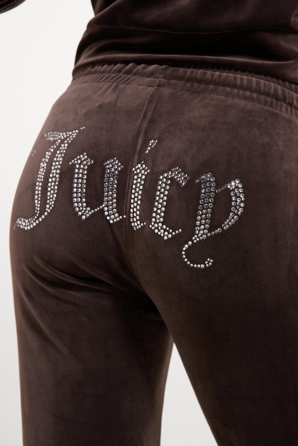 Displays a model wearing the Java 'Juicy' branded Velour Diamanté Tracksuit Bottom