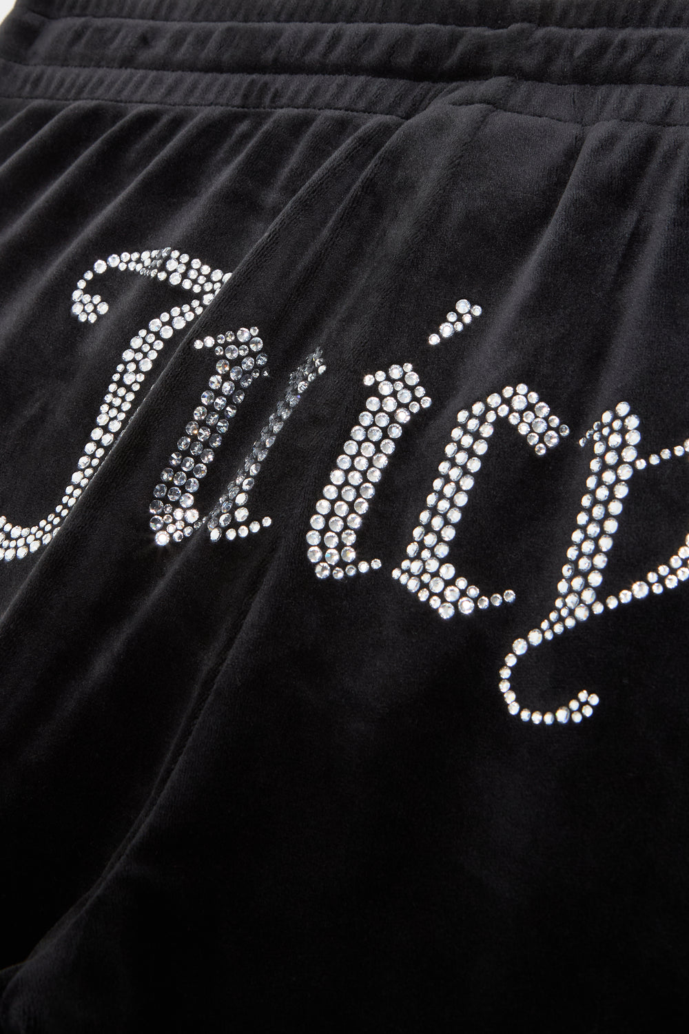 Displays the Black 'Juicy' branded velour tracksuit bottoms featuring the juicy branding 