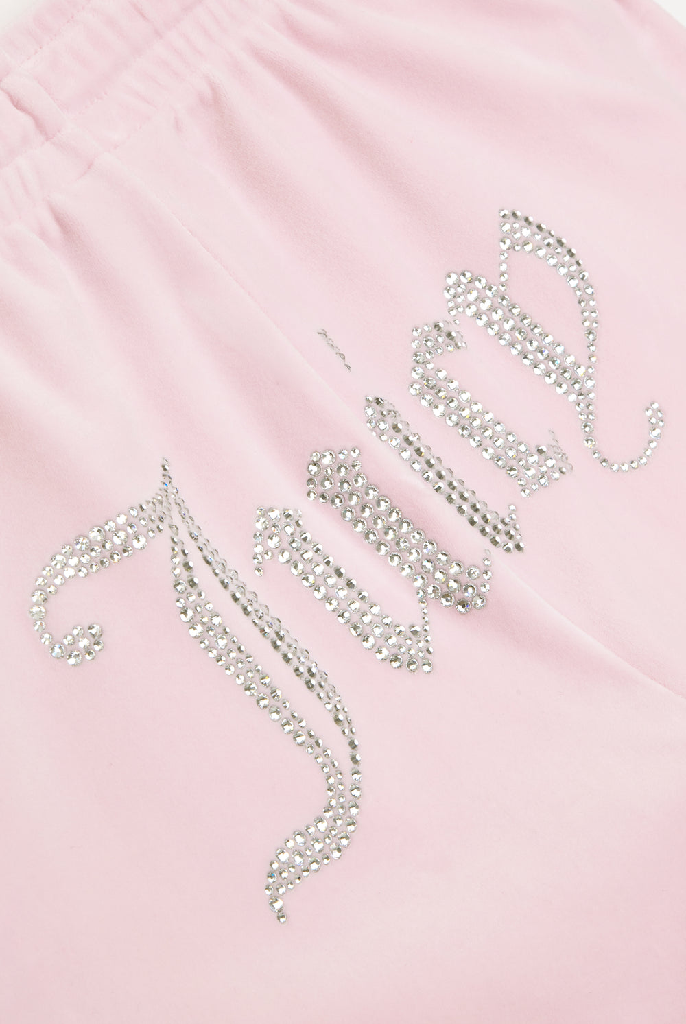 Displays the Almond Blossom 'Juicy' branded velour diamanté tracksuit bottom featuring the juicy branding