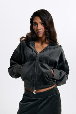 Displays a model wearing the Raven 'Juicy' branded Velour Bonded Hoodie
