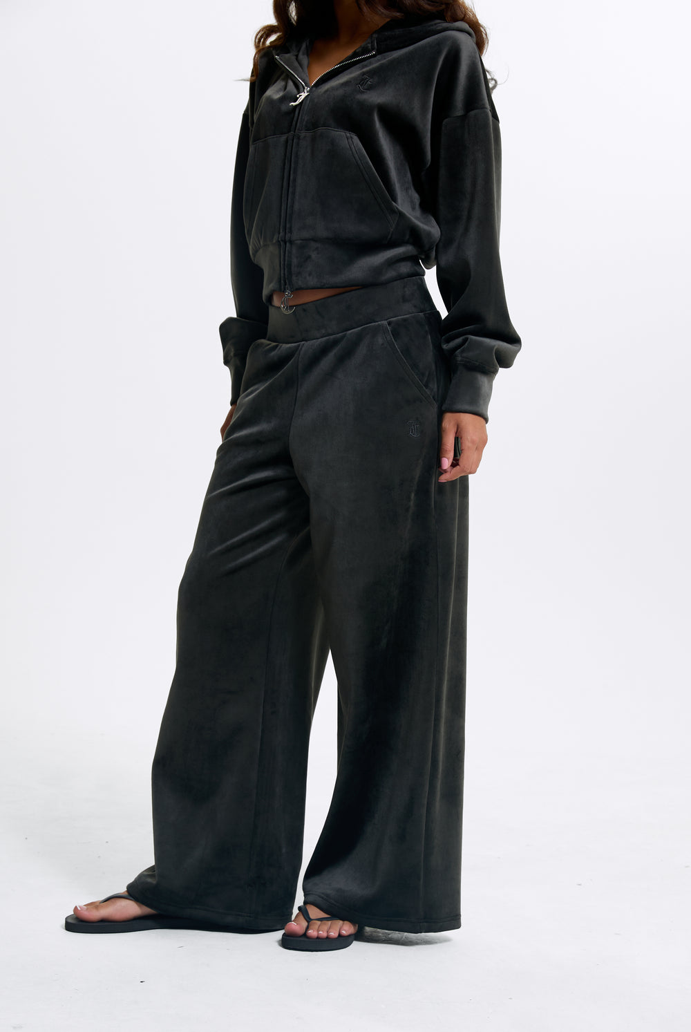 Displays a model wearing the Raven 'Juicy' branded Velour Bonded Tracksuit Bottom