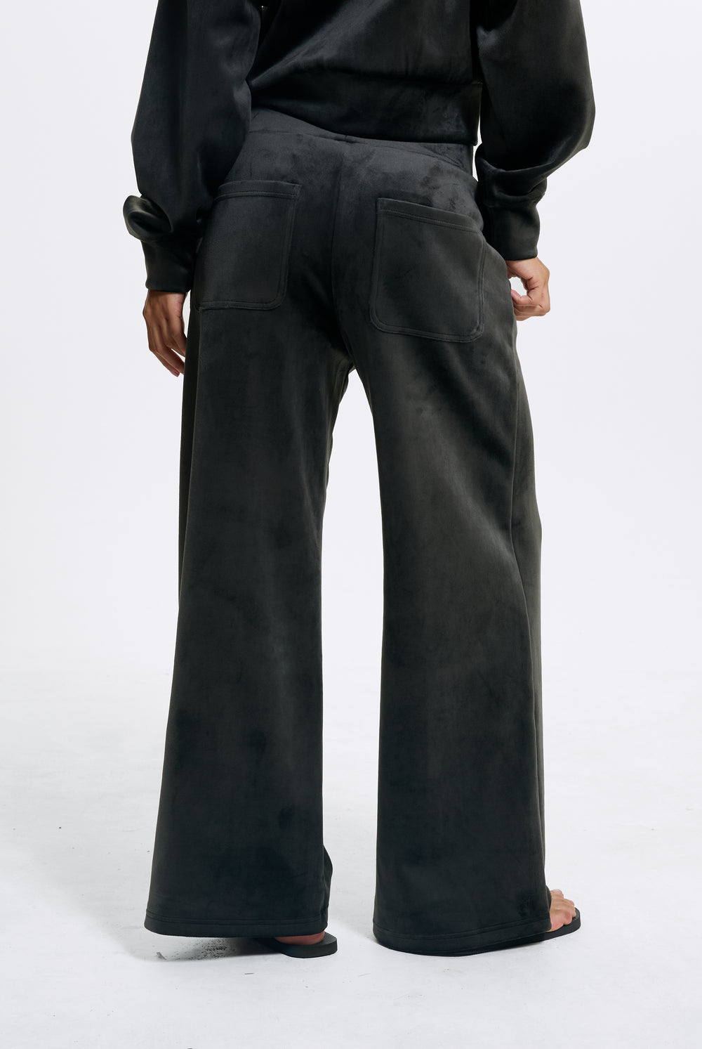 Displays a model wearing the Raven 'Juicy' branded Velour Bonded Tracksuit Bottom