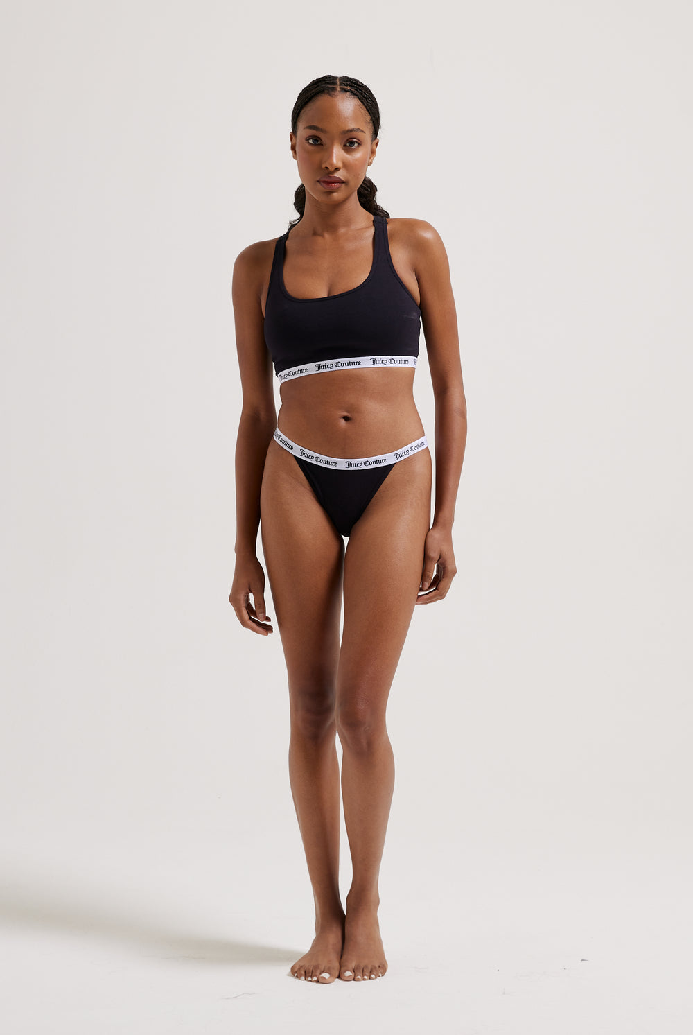 Displays a model wearing the black 'Juicy' branded cotton waistband briefs 