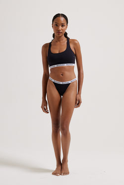 Displays a model wearing the black 'Juicy' branded cotton waistband briefs 