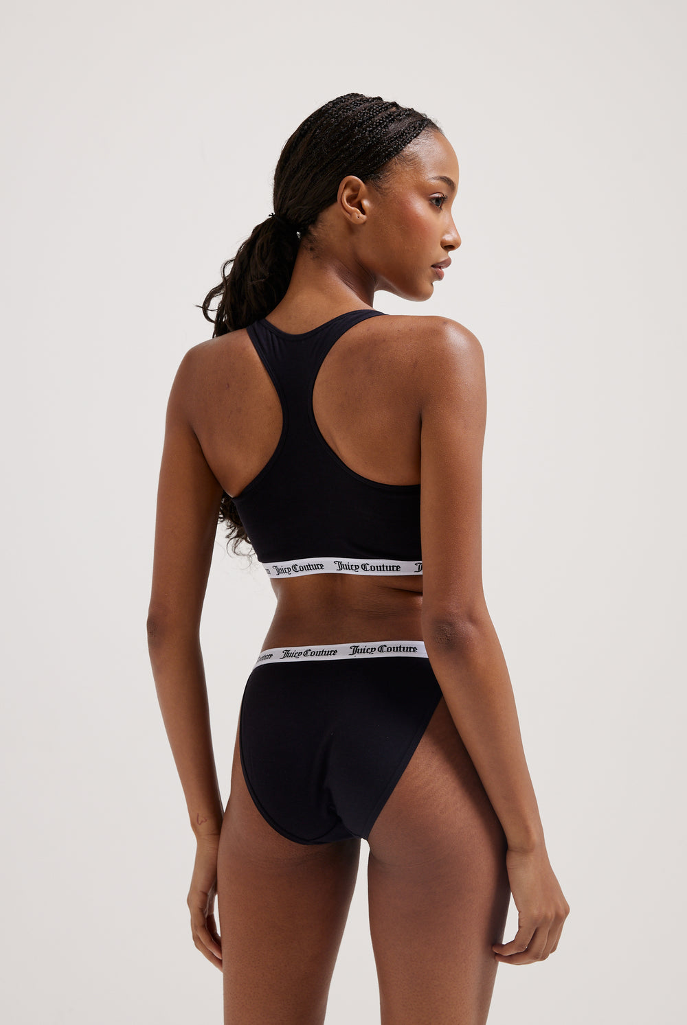 Displays a model wearing the black 'Juicy' branded cotton waistband briefs 