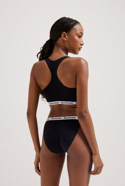 Displays a model wearing the black 'Juicy' branded cotton waistband briefs 