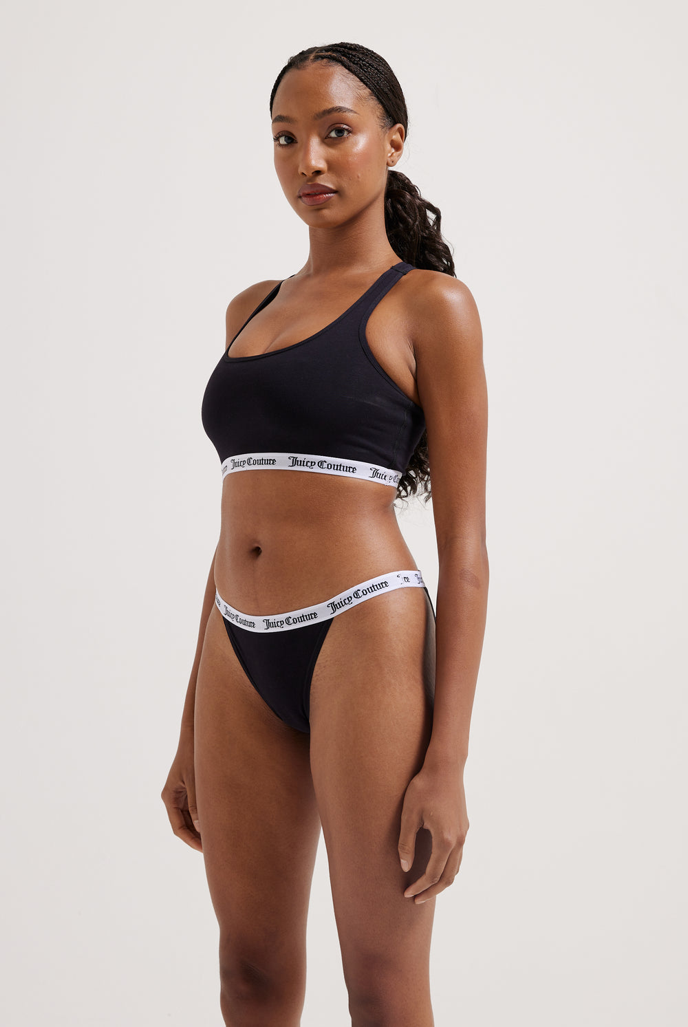 Displays a model wearing the black 'Juicy' branded cotton waistband briefs 