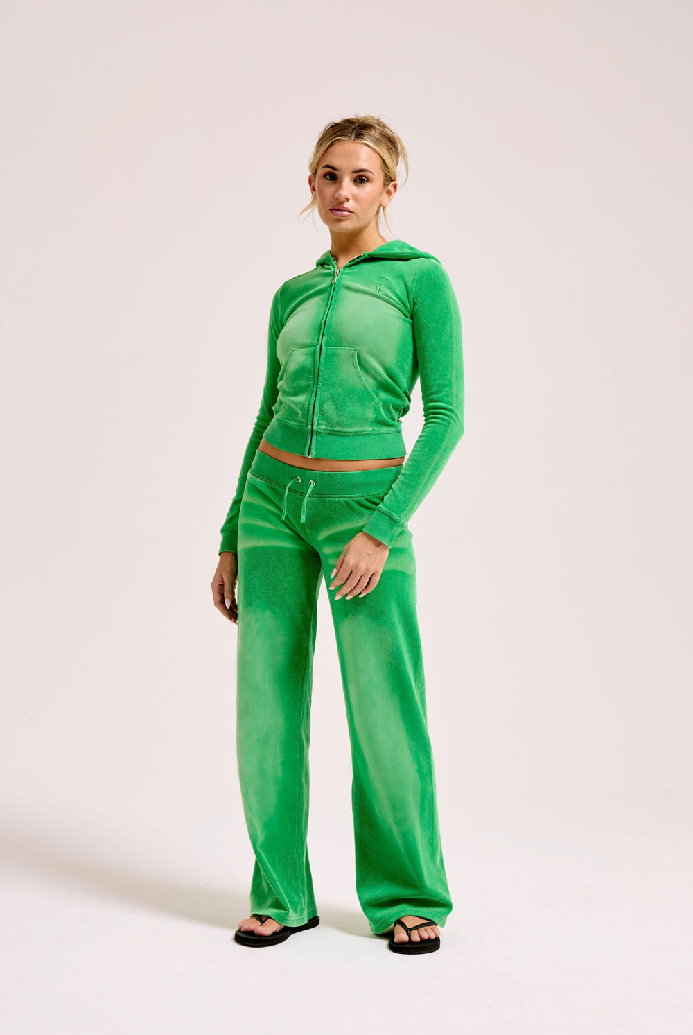 Displays a model wearing the Jolly Green washed 'Juicy' branded OG straight track pant 