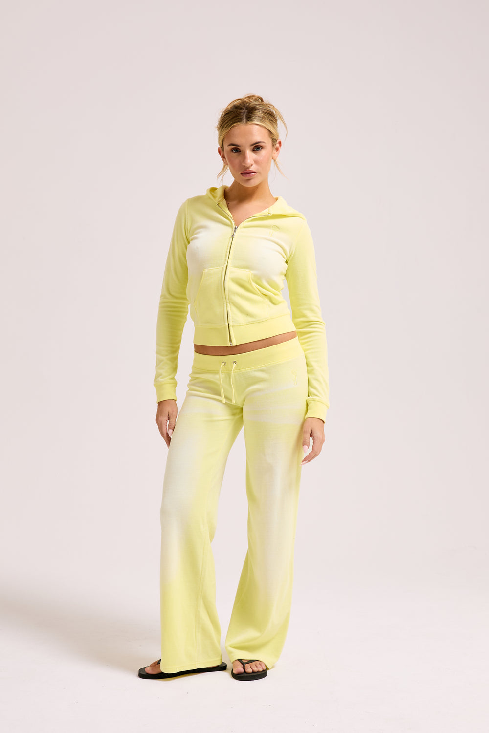 Display a model wearing the Yellow Pear washed 'Juicy' branded cotton velour fitted hoodie 