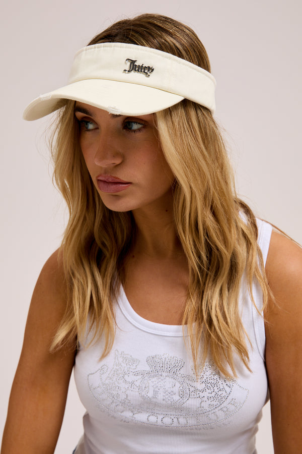 Displays a model wearing the ecru distressed 'Juicy' branded cotton denim visor 