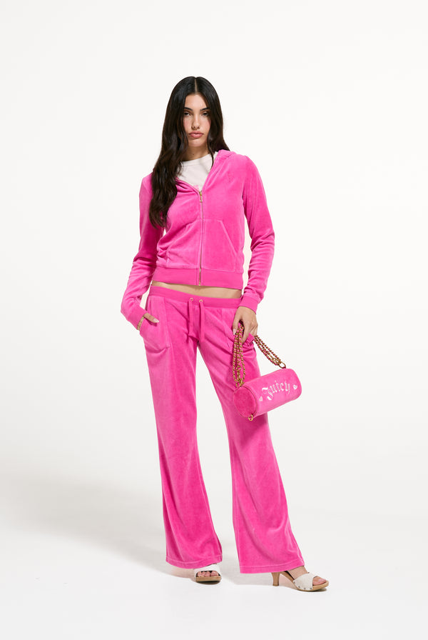 Displays a model wearing the Nostalgia Pink 'Juicy' branded Washed Robyn Hoodie