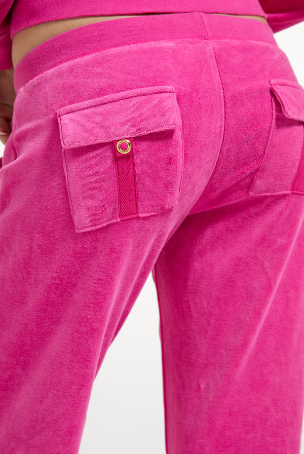 Displays a model wearing the Nostalgia Pink 'Juicy' branded Washed Caisa Ultra Low Rise Pant