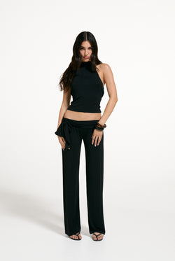 Displays a model wearing the Black 'Juicy' branded Belted Flare Trousers