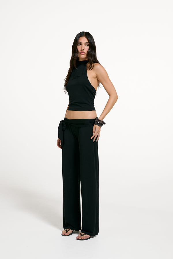 Displays a model wearing the Black 'Juicy' branded Belted Flare Trousers