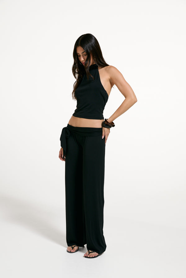Displays a model wearing the Black 'Juicy' branded Belted Flare Trousers