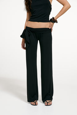 Displays a model wearing the Black 'Juicy' branded Belted Flare Trousers